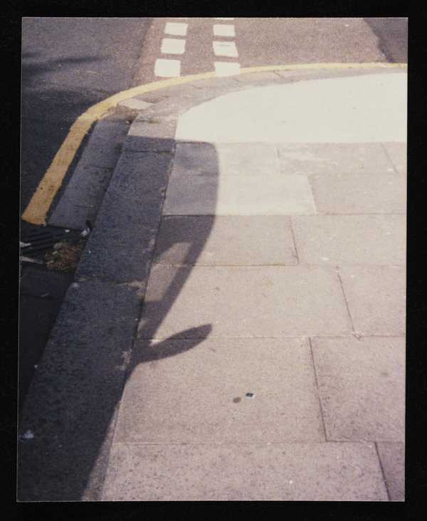 Colour Photograph Of The Shadow Of A Car On The Pavement Prunella