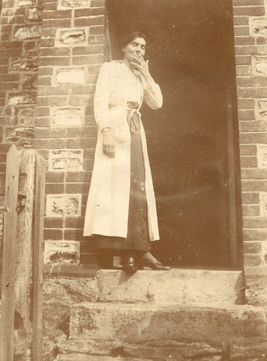 Stanislawa de Karlowska smoking in the doorway of Lytchetts in Devon c.1917–18