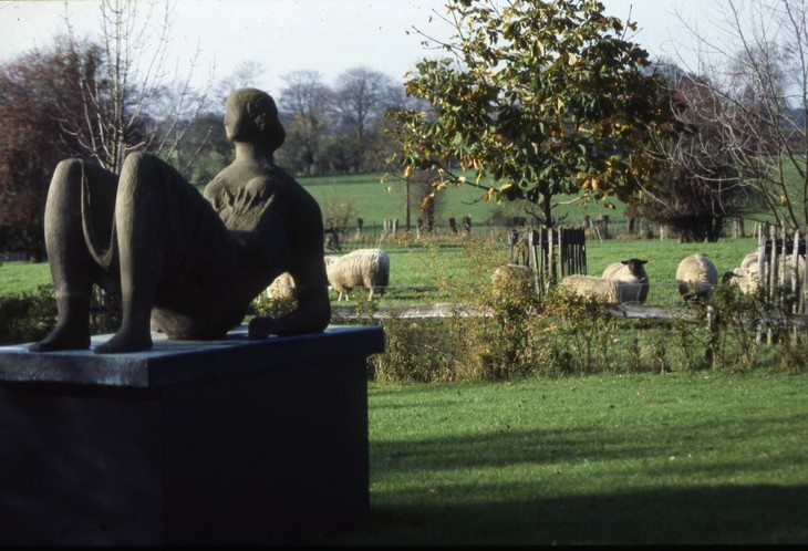 Gemma Levine 'Henry Moore's 'Draped Reclining Figure' 1952–3 in cast concrete, and sheep in the field at the Hoglands's estate c.1984'