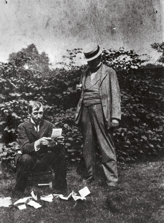 Spencer Gore and Walter Sickert reading press cuttings of the first Camden Town Group exhibition in the garden of Rowlandson House June 1911