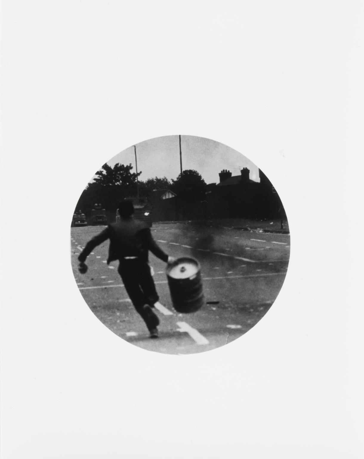 P13221: Untitled (Boy running with barrel)