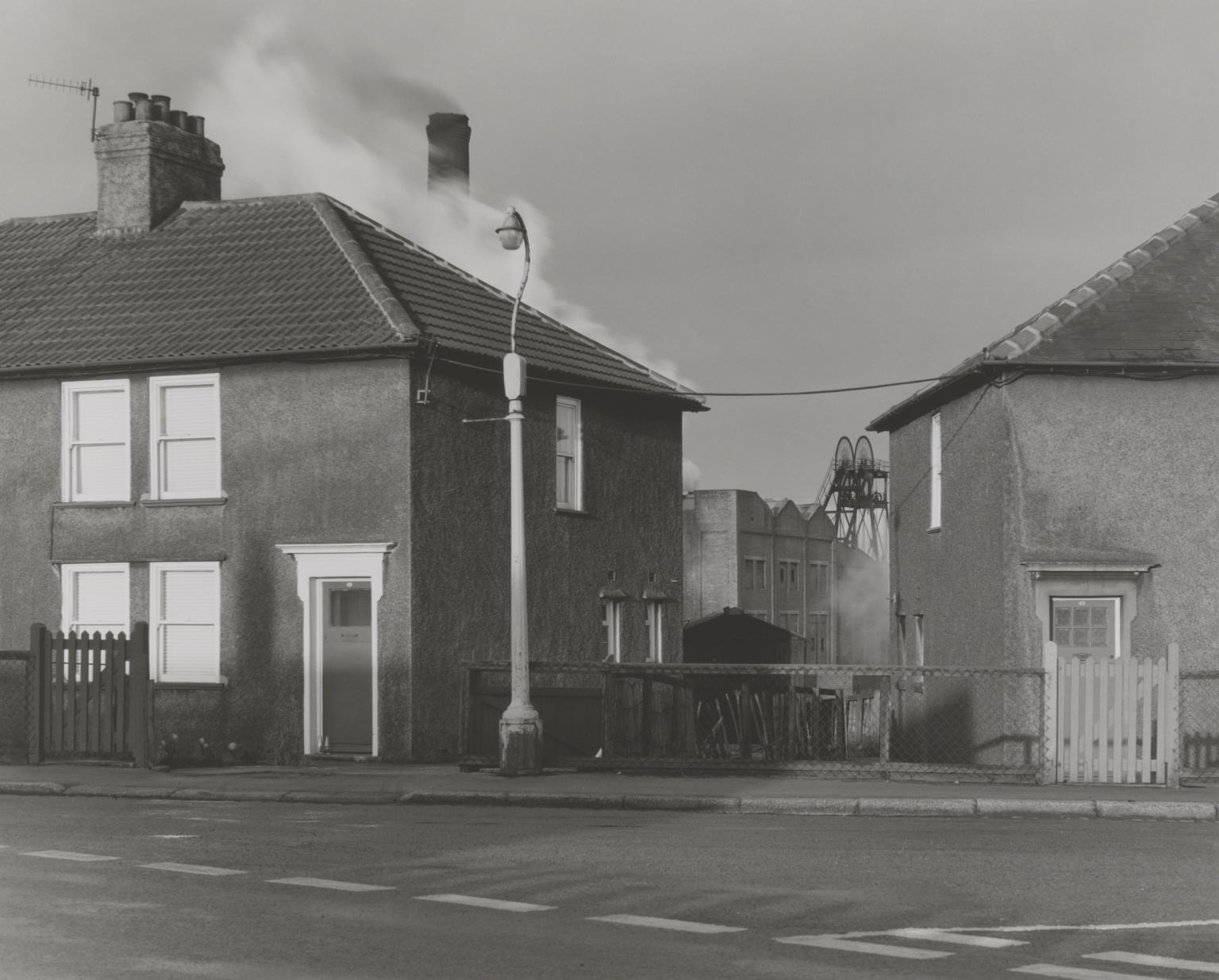 P81021: Houses with Pit Wheel in Background. Workington
