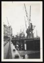 Prunella Clough, ‘Black and white photograph of cranes by a dock or canal’ [1950s]