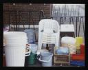 Prunella Clough, ‘Colour photograph of plastic chairs, bins, buckets and baskets stacked up outside’ [1990s]
