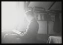 Major H. O. Daniel, ‘Photograph of internee reading at Hutchinson Internment Camp’ [c.1940–1]