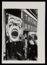 Anonymous, ‘Black and white photograph of Dougie Thomson holding a large clown placard next to a tattoo artist’s shop in Glasgow’ [c.1978]