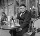 Nigel Henderson, ‘Photograph of Eduardo Paolozzi sitting outside a cafe’ [c.1949–c.1956]