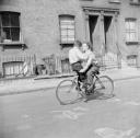 Nigel Henderson, ‘Photograph of Brian and Leslie Samuels on a bicycle’ [1953]