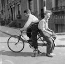 Nigel Henderson, ‘Photograph of Brian and Leslie Samuels on a bicycle’ [1953]