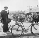 Nigel Henderson, ‘Photograph showing an unidentified man standing next to a bicycle at Chrisp Street Market, London’ [1953]