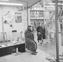 Nigel Henderson, ‘Photograph showing an unidentified man in a shop doorway’ [c.1949–c.1956]