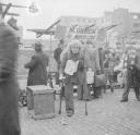 Nigel Henderson, ‘Photograph showing an unidentified man with crutches at an outdoor market’ [c.1949–c.1956]