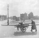 Nigel Henderson, ‘Photograph showing a street vendor pushing a cart’ [c.1949–c.1956]