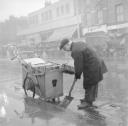 Nigel Henderson, ‘Photograph showing a street cleaner’ [c.1949–c.1956]