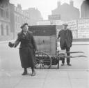 Nigel Henderson, ‘Photograph showing an unidentified woman and a street vendor with a cart’ [c.1953–c.1956]