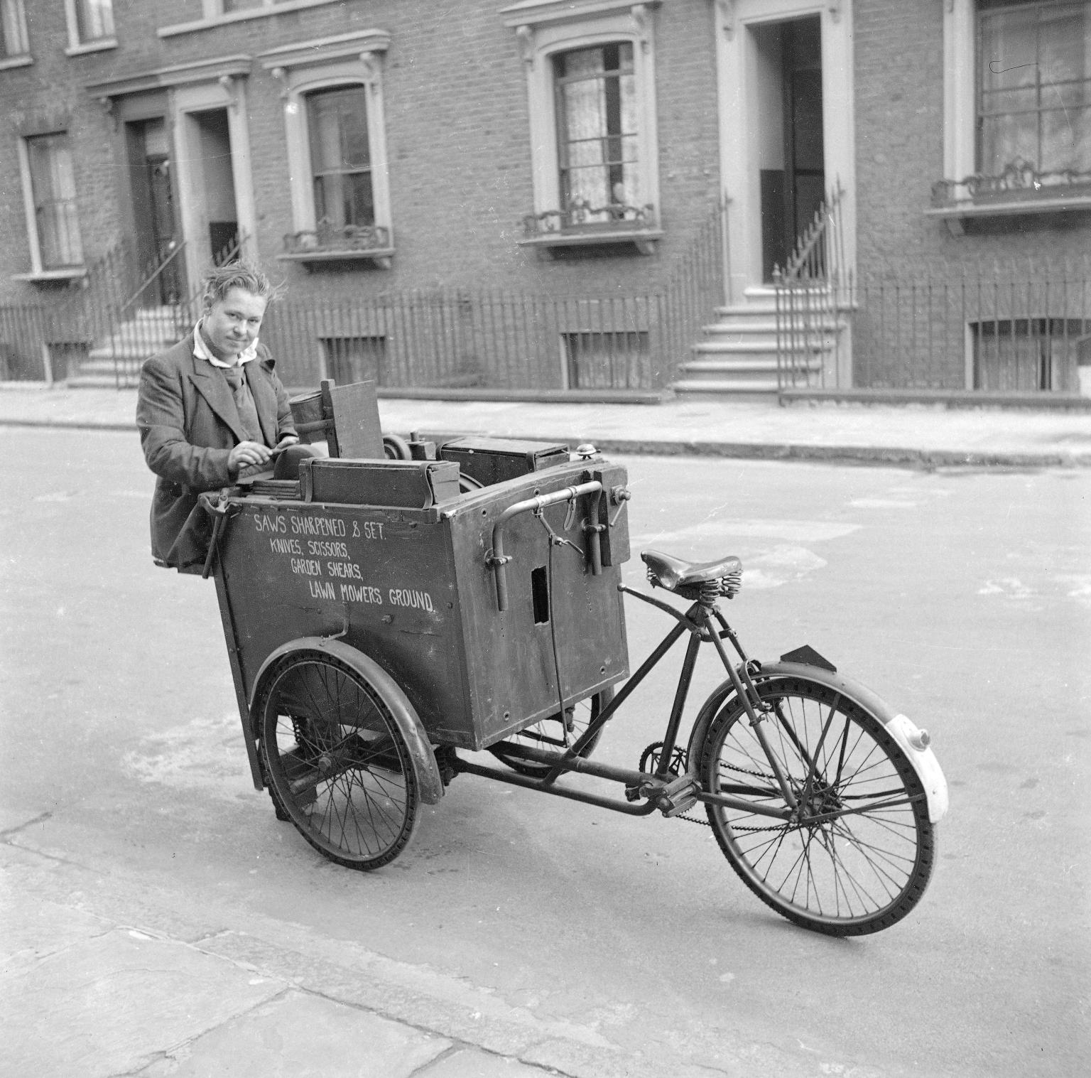 Photograph showing a knife grinder sharpening a knife on his cart', Nigel  Henderson, [c.1949–c.1956]', Nigel Henderson, [c.1949–c.1956] – Tate  Archive