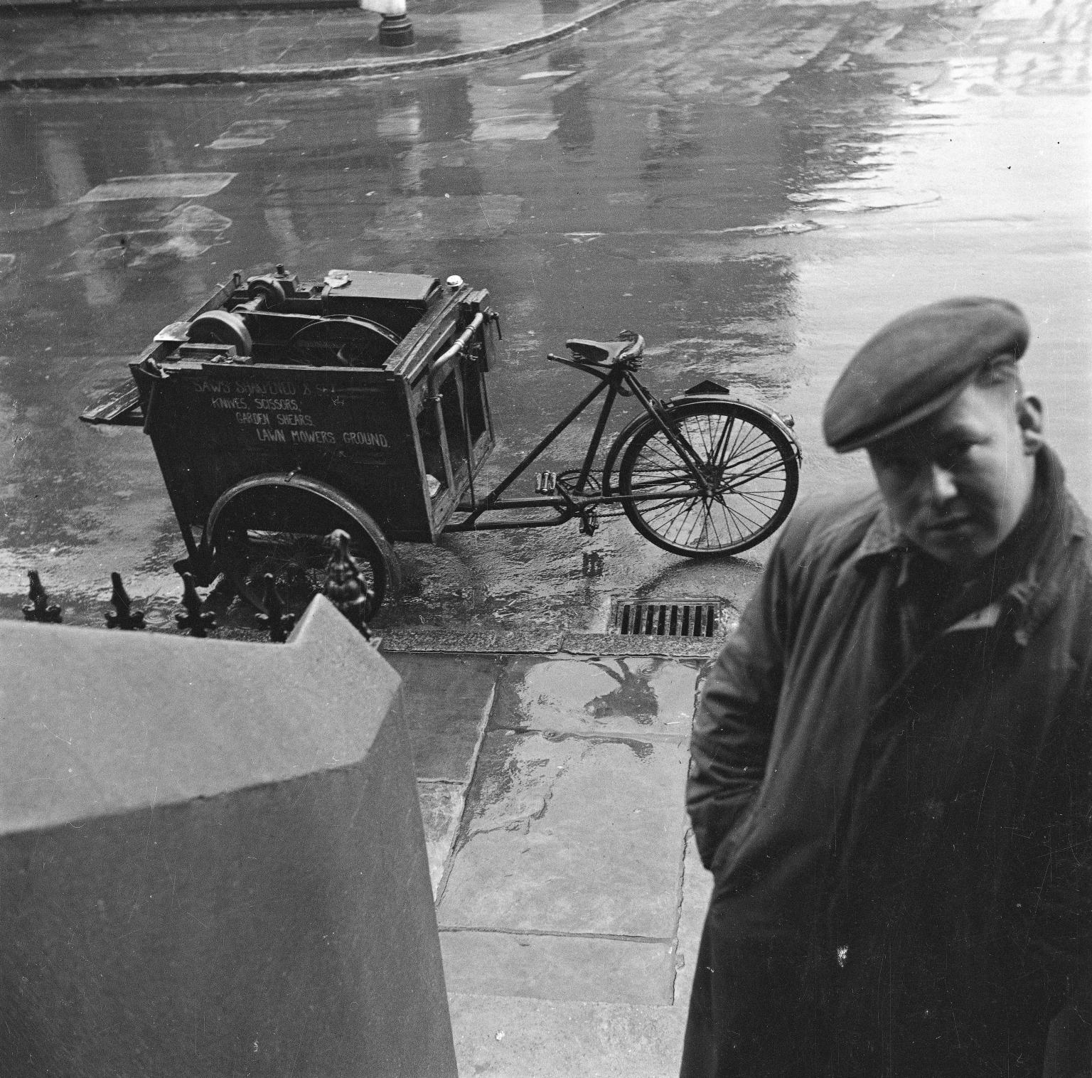 Photograph showing a knife grinder sharpening a knife on his cart', Nigel  Henderson, [c.1949–c.1956]', Nigel Henderson, [c.1949–c.1956] – Tate  Archive