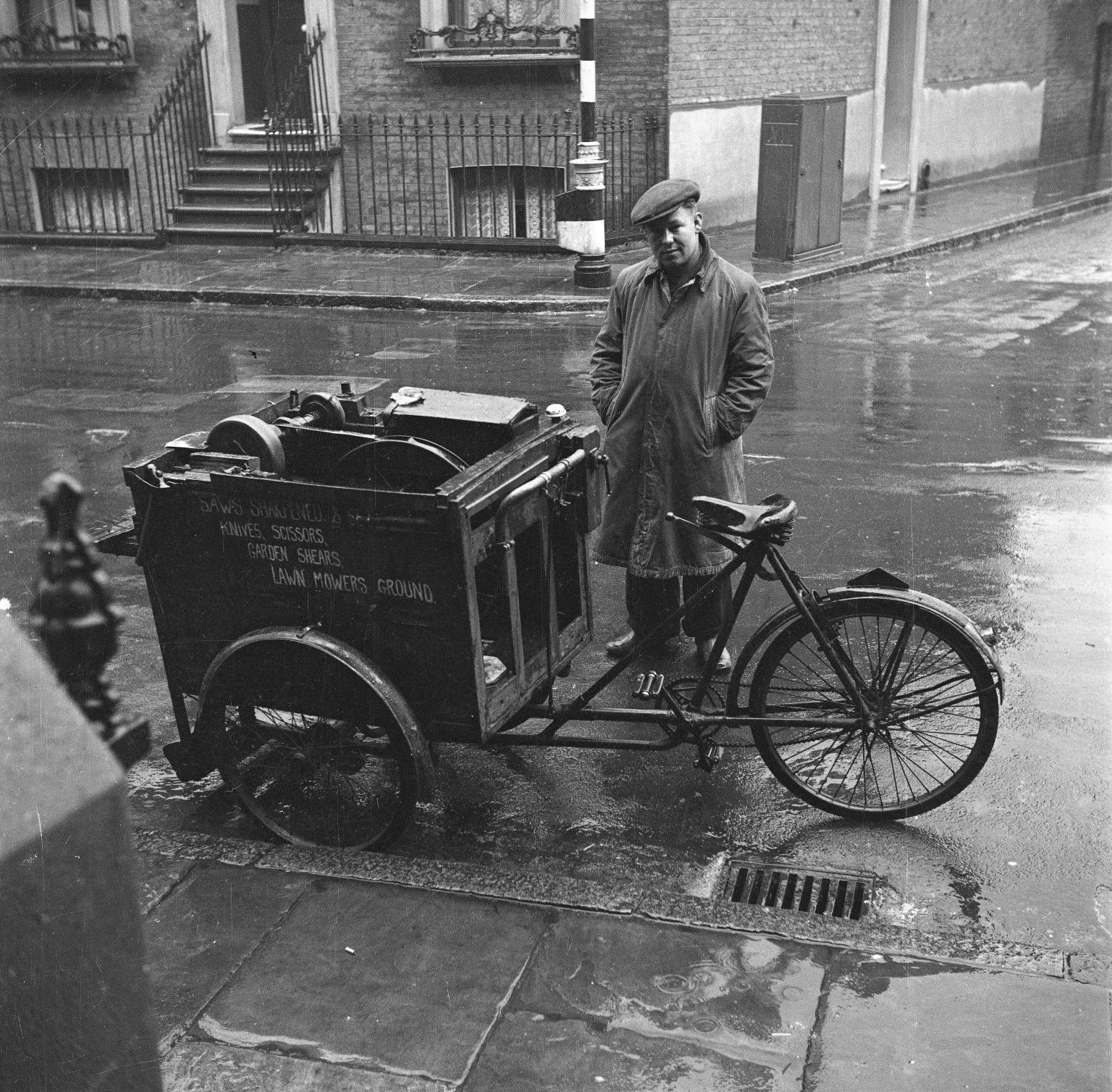 Photograph showing a knife grinder sharpening a knife on his cart', Nigel  Henderson, [c.1949–c.1956]', Nigel Henderson, [c.1949–c.1956] – Tate  Archive