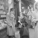 Nigel Henderson, ‘Photograph of an unidentified man and woman outside a bakery’ [c.1949–c.1956]