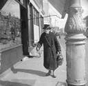 Nigel Henderson, ‘Photograph of an unidentified woman outside a shop’ [c.1949–c.1956]