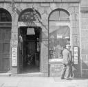 Nigel Henderson, ‘Photograph showing shop front of G. Walker, hairdresser and tobacconist’ [c.1949–c.1956]