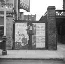 Nigel Henderson, ‘Photograph showing advertisements posters attached to a gate on an unidentified street’ [c.1949–c.1956]