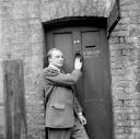 Nigel Henderson, ‘Photograph of Harry Craig in front of door to W.J. Waterer, sword cutter ’ [c.1949–c.1956]