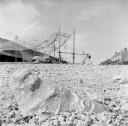 Nigel Henderson, ‘Photograph showing a stone beach, hanging fishing nets in background’ [c.1949–c.1956]