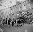 Nigel Henderson, ‘Photograph showing school children celebrating at a street event for the Coronation’ [1953]