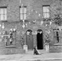 Nigel Henderson, ‘Photograph showing house fronts decorated with bunting to mark the Coronation’ [1953]