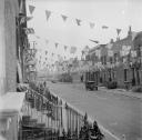 Nigel Henderson, ‘Photograph showing an unidentified street decorated with bunting to mark the Coronation’ [1953]