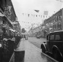 Nigel Henderson, ‘Photograph showing an unidentified street decorated with bunting to mark the Coronation’ [1953]