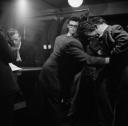 Nigel Henderson, ‘Photograph showing musicians inside a shop selling men’s clothes including Derek Humble’ [c.1949–c.1956]