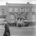 Nigel Henderson, ‘Photograph showing house fronts decorated with a union jack flag to mark the Coronation’ [1953]
