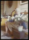Unknown Photographer, ‘Photograph of Marie-Louise von Motesiczky seated on a low bench beside a small table with a flowering plant’ [c.1970s–1980s]