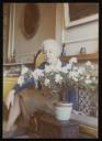 Unknown Photographer, ‘Photograph of Marie-Louise von Motesiczky seated on a low bench beside a small table with a flowering plant’ [c.1970s–1980s]