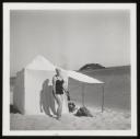 Unknown Photographer, ‘Photograph of Marie-Louise von Motesiczky in a bathing suit, standing next to a tent beside the sea’ [c.1930s]