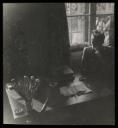 Unknown Photographer, ‘Photograph of Marie-Louise von Motesiczky seated by a window next to a table holding a jar of paintbrushes and some books’ [c.1940s–1950s]