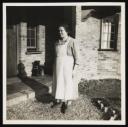 Unknown Photographer, ‘Photograph of Marie Hauptmann in an apron standing in front of a house ’ [c.1940s]