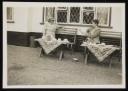 Unknown Photographer, ‘Photograph of Marie Hauptmann and Marie-Louise von Motesiczky seated on benches outside a house with tables set with tea things ’ [c.1940s–1954]