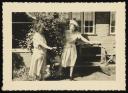 Unknown Photographer, ‘Photograph of Marie Hauptmann and Marie-Louise von Motesiczky standing behind a washing line and looking at each other from either side of a bush ’ [c.1940s–1954] 