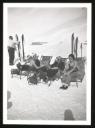 Unknown Photographer, ‘Photograph of a man standing looking at a pair of skis and Marie-Louise Motesiczky, with her uncle Ernst von Lieben and two other young women sitting on deck-chairs talking in Switzerland’ [1920s–1930s]