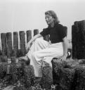 Joseph Bard, ‘Photograph of Eileen Agar sitting by concrete posts (possibly groynes) by the sea’ September 1938