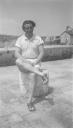 Eileen Agar, ‘Photograph of Joseph Bard sitting on a concrete post at a harbour in Bridport, Dorset’ 1934