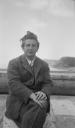 Eileen Agar, ‘Photograph of Joseph Bard in a suit sitting on a concrete post by the harbour in Bridport, Dorset’ 1934