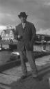 Eileen Agar, ‘Photograph of Joseph Bard in a suit by a harbour’ [1934]