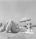 Eileen Agar, ‘Photograph of Joseph Bard lying on the beach with a sunshade in Juan-les-Pins, France’ 1937