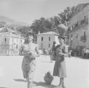 Nigel Henderson, ‘Photograph of two unidentified women in the town square, one woman is carrying an amphora on her head’ [c.1951–2]