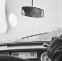 Nigel Henderson, ‘Photograph showing the interior of a car with a man’s reflection in the rear view mirror’ [1949–54]