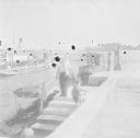 Nigel Henderson, ‘Photograph of an unidentified man beside docked boats, possibly in Venice’ [c.1951–2]